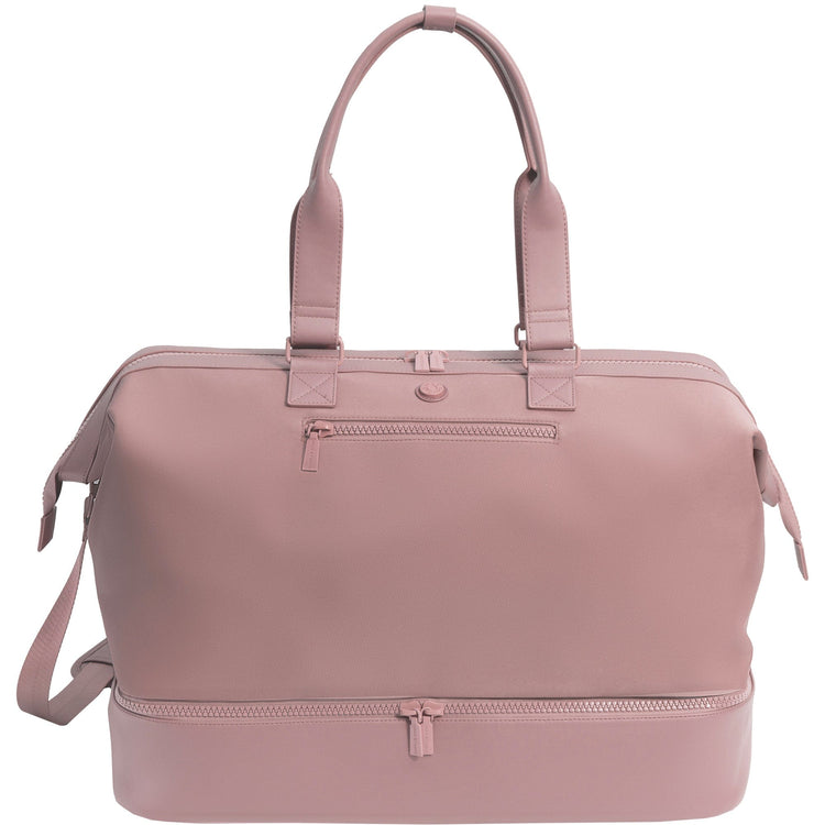 Pink duffel bag with handles and a shoulder strap on a white background