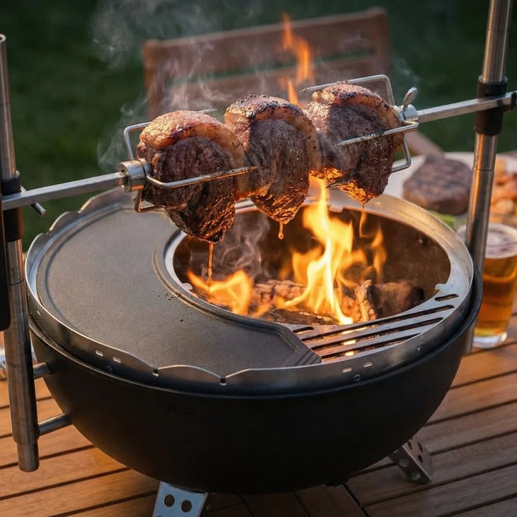 Grill with skewers of meat over an open flame on a wooden deck.
