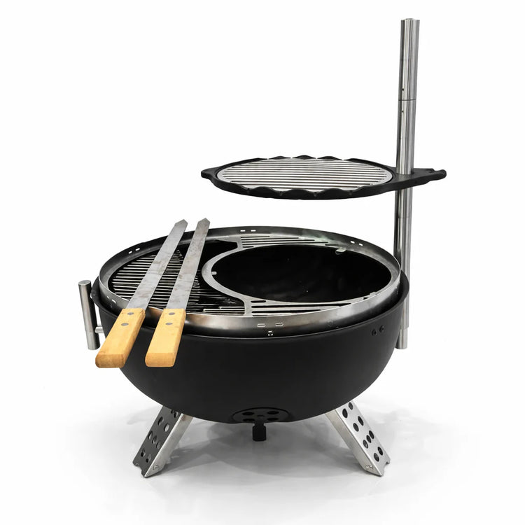 Portable grill with two grilling plates and tongs on a white background