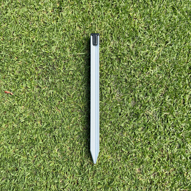 Metal stake on a grassy surface