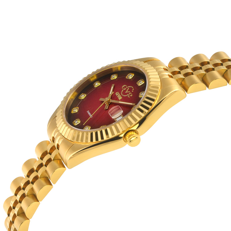 Gold wristwatch with a red face on a white background