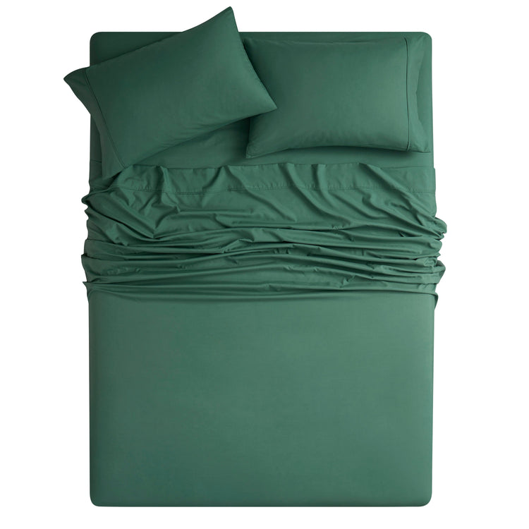 Green bedding set with fitted sheet, flat sheet, and pillowcases on a white background