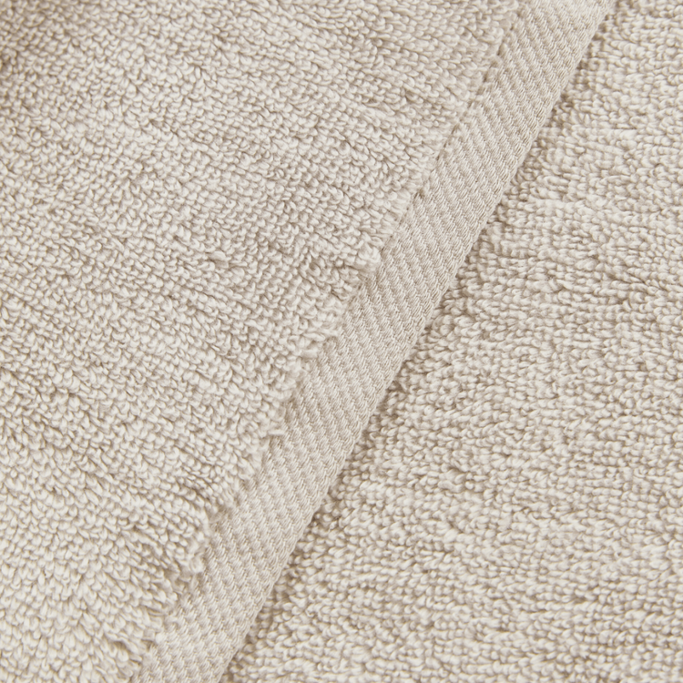 Close-up of beige textured fabric with a subtle pattern