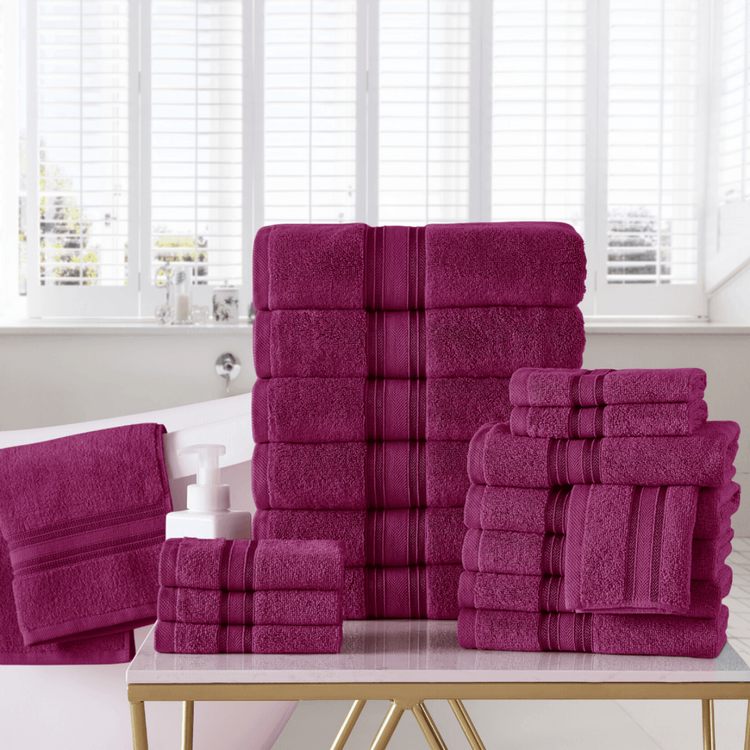 Stack of purple towels on a table with a window in the background