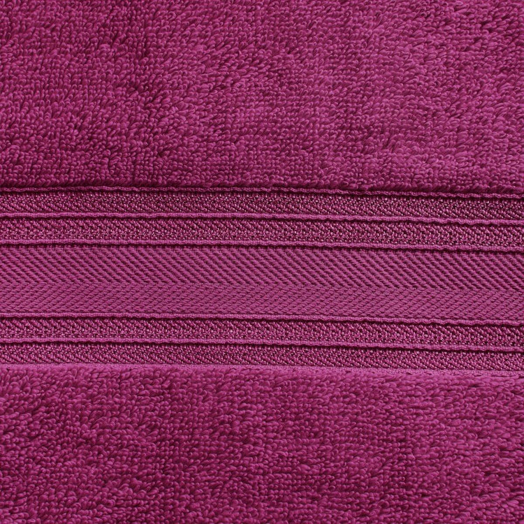 Close-up of a purple zipper on a textured purple fabric background