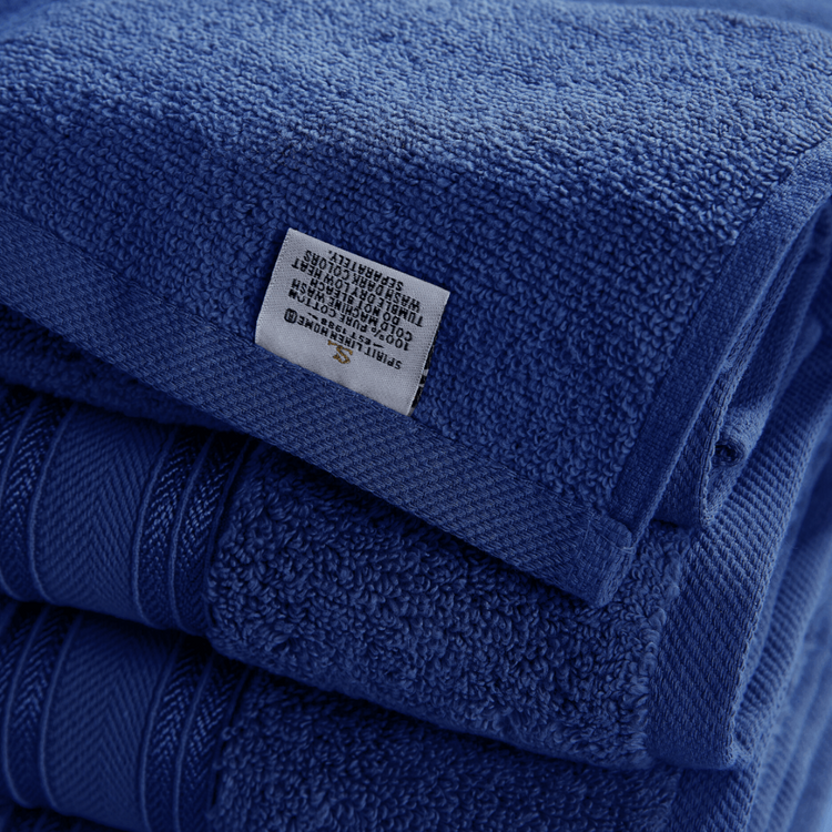 Stack of blue towels with a label on a white background
