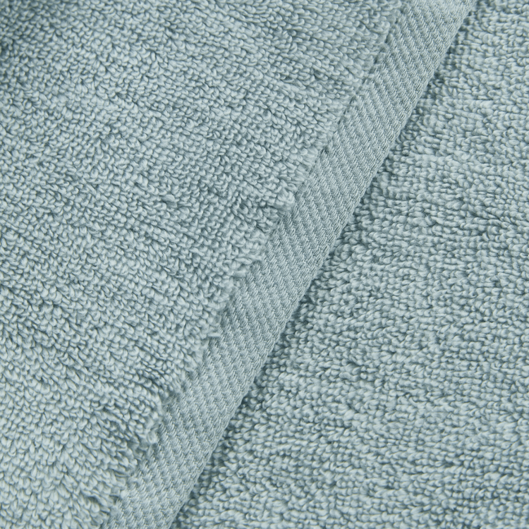 Close-up of textured teal fabric with a slight pattern