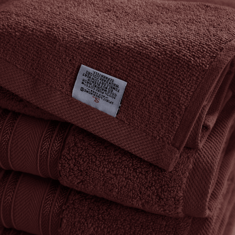 Stack of brown towels with a label on top
