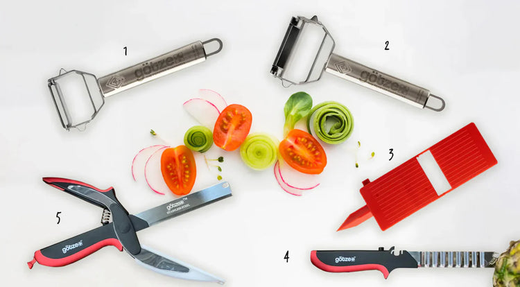 Set of kitchen tools including a peeler, mandoline, and other cutting tools with sliced vegetables on a white background.