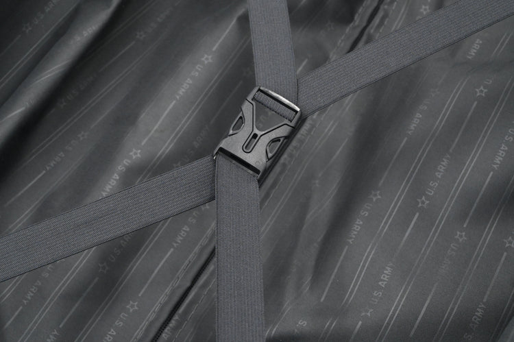 Close-up of a gray strap with a buckle on a textured gray background