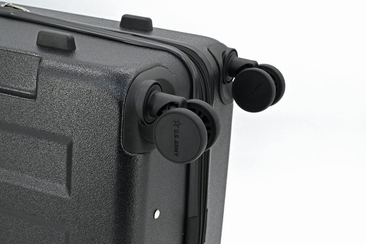 Close-up of a black suitcase with wheels on a white background