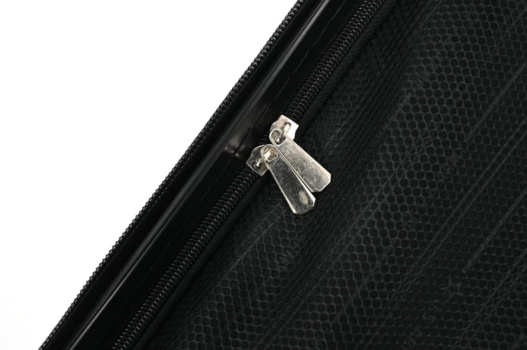 Close-up of a black suitcase with a silver zipper pull on a white background