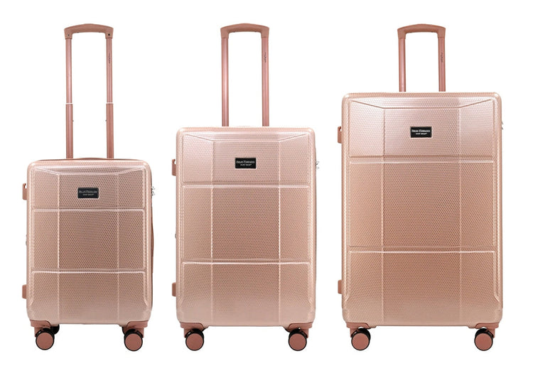 Set of three rose gold suitcases of different sizes on a white background