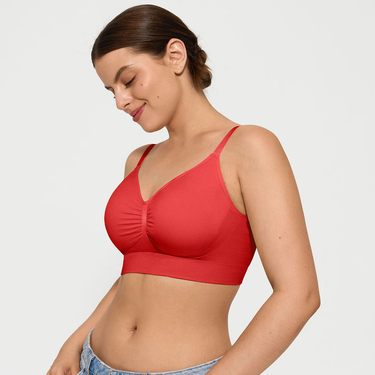 Woman wearing a red bralette against a plain background