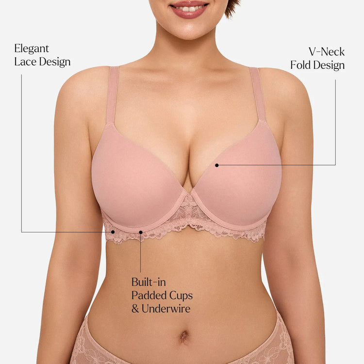 A woman wearing a light pink bra with lace trim, shown from the chest to the hips against a light gray background. Black text callouts point to features including elegant lace design, V-neck fold design, built-in padded cups, and underwire.