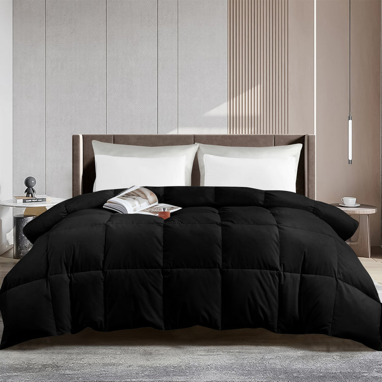 Black comforter on a bed in a modern bedroom setting