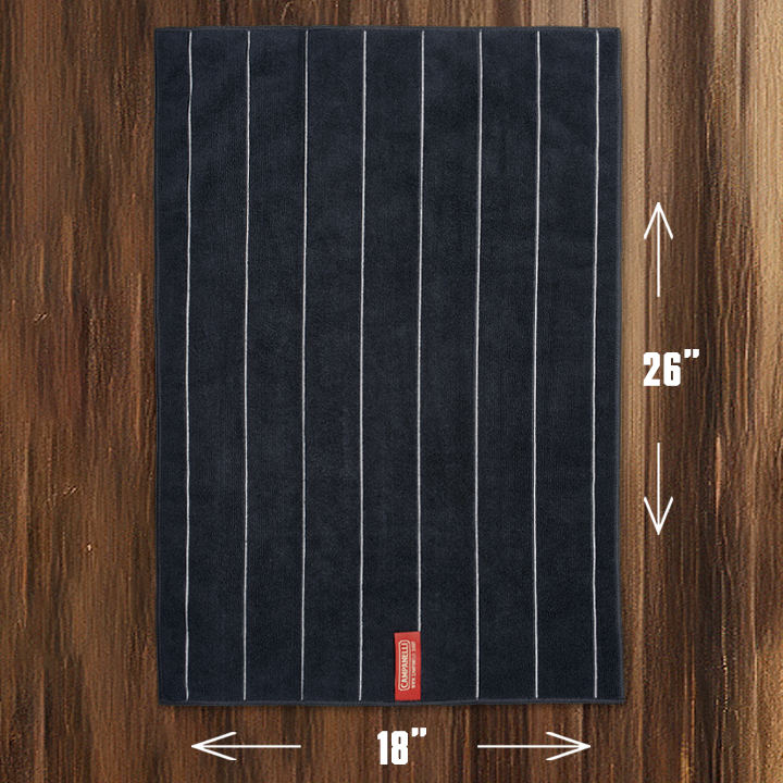 Navy blue towel with white stripes on a wooden surface, showing dimensions.