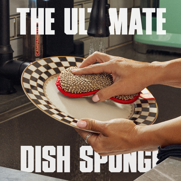 Person using a dish sponge on a checkered plate with text 'The Ultimate Dish Sponge' in a kitchen setting.