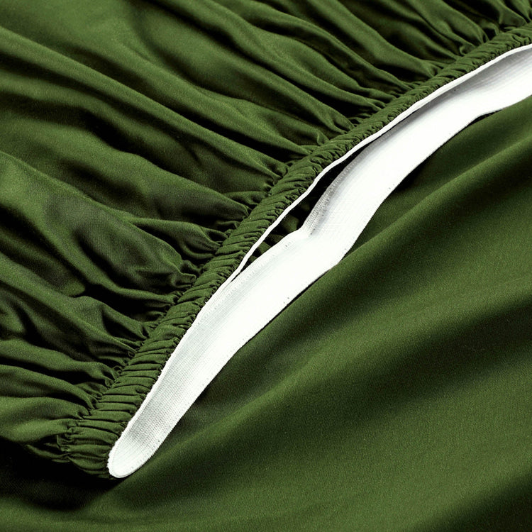 Close-up of green fitted sheet with white edge