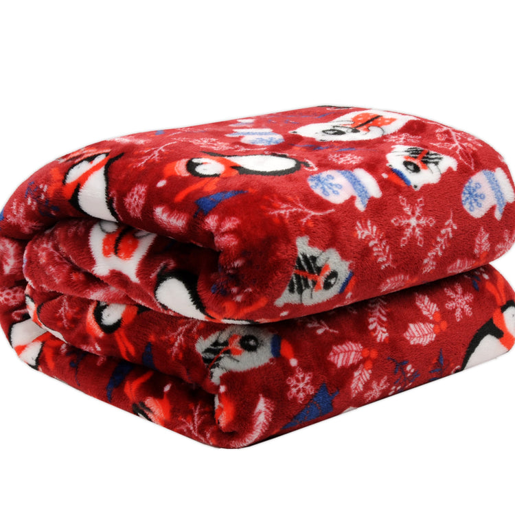 Folded red blanket with cartoon character pattern on a white background