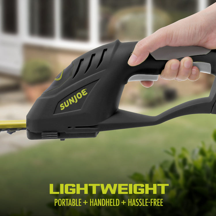 Handheld gardening tool with 'Sun Joe' branding, held by a person outdoors.