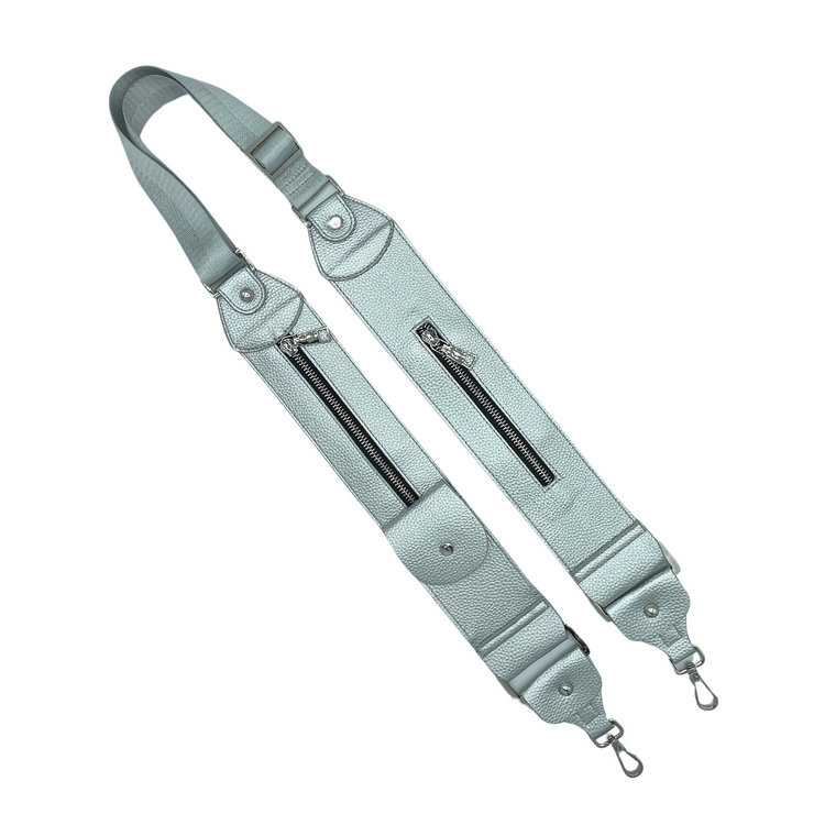 Adjustable black strap with zipper pockets and D-ring tabs, made of pebbled imitation leather, designed to be worn over the shoulder.