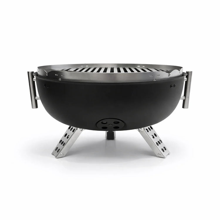 Black portable grill with metal legs on a white background