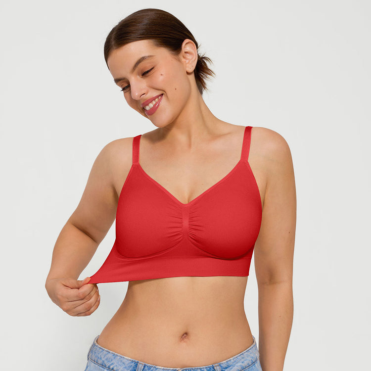 Woman wearing a red bralette against a plain background