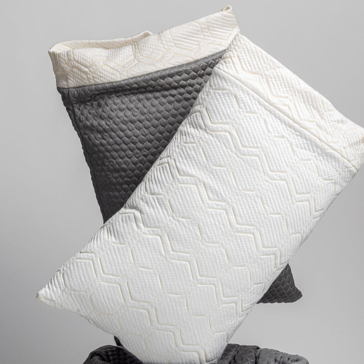 White and gray textured pillows on a light gray background