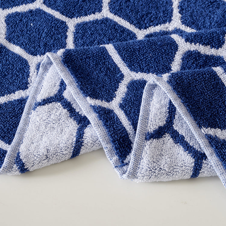Blue and white geometric patterned rug on a light background