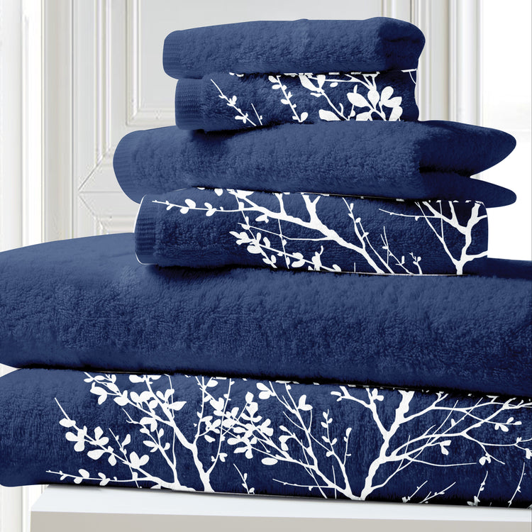 Stack of blue towels with white floral patterns on a white background