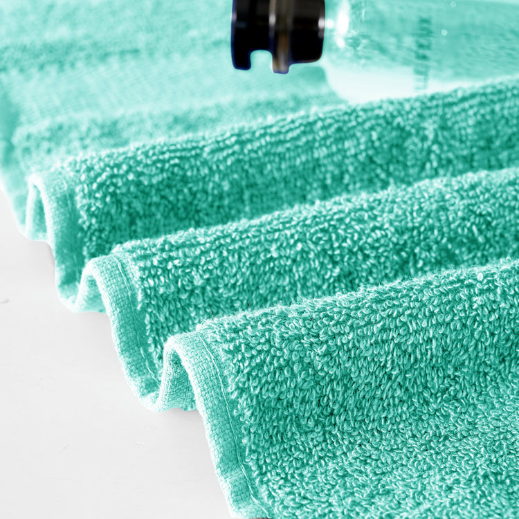 Close-up of green microfiber cloths on a white surface