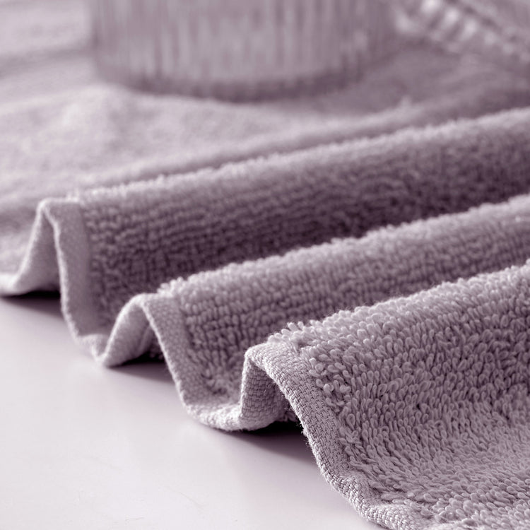 Stack of gray textured towels on a light surface