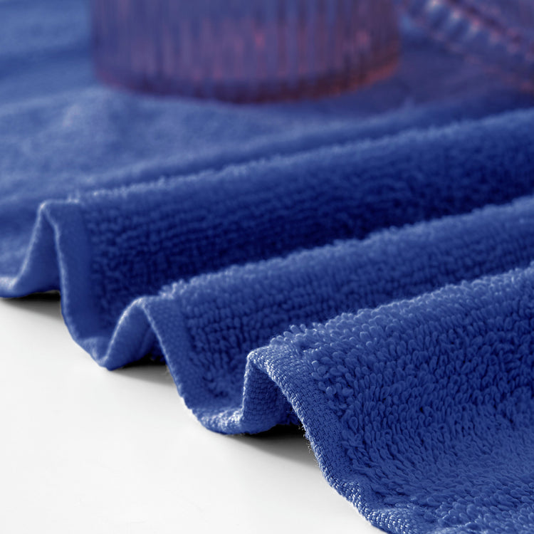 Close-up of a blue textured towel on a white surface