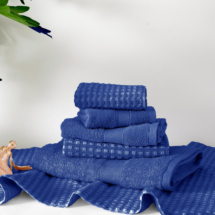 Stack of blue towels on a white background