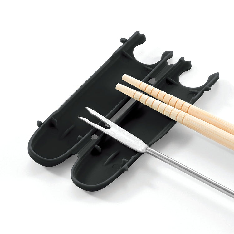 Black grill tool holder with skewers and tongs on a white background