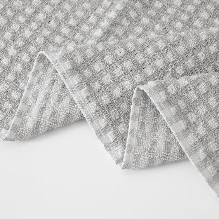 Gray textured fabric with a checkered pattern on a white background