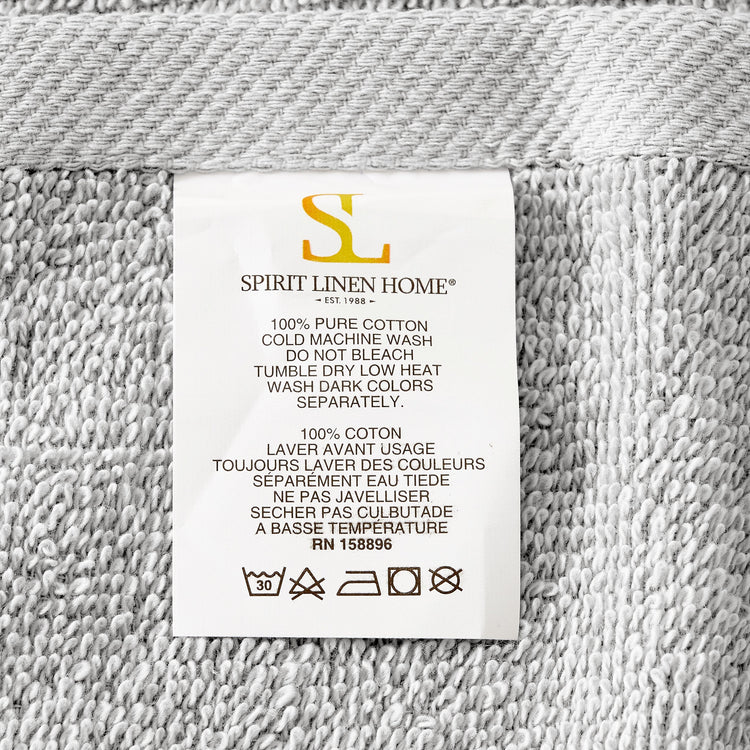 Fabric label with 'Spirit Linen Home' branding on a textured fabric background