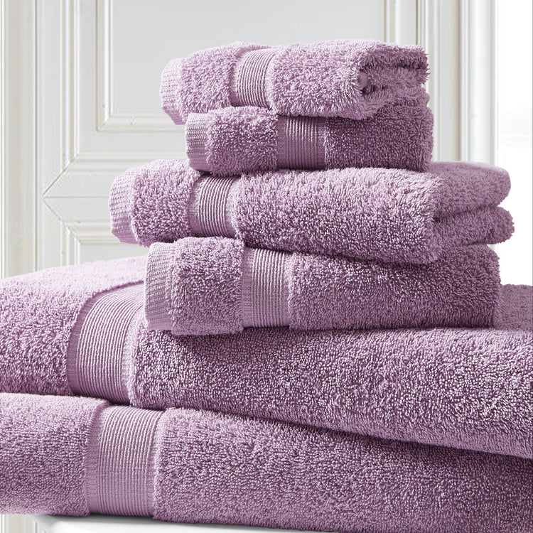 Stack of purple towels on a white surface with a light background