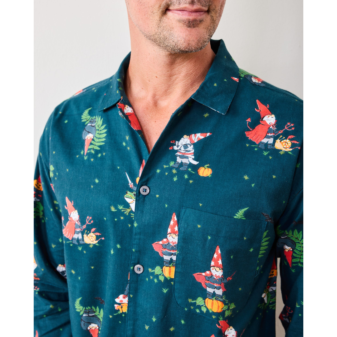 Man wearing a teal shirt with gnome pattern against a plain background