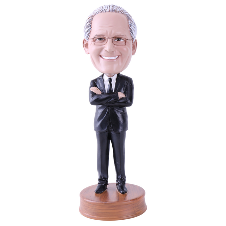 Bobblehead figure of a man in a suit on a white background