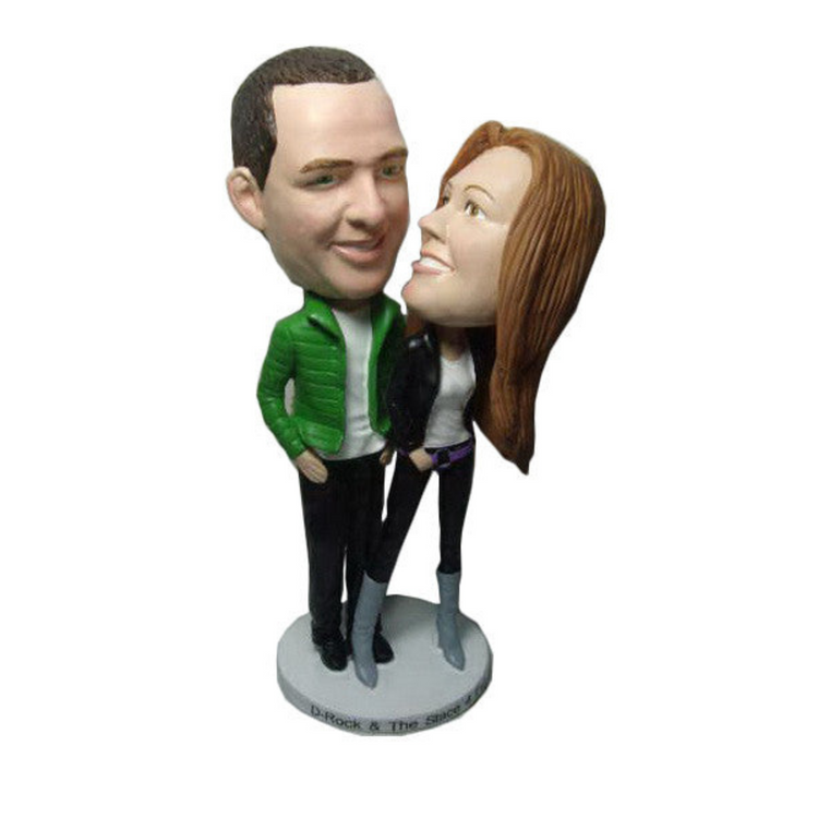 Bobblehead figurine of a man and woman on a white background