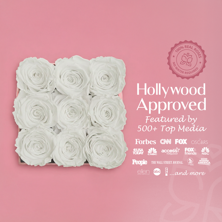White roses in a box with 'Hollywood Approved' text and media logos on a pink background