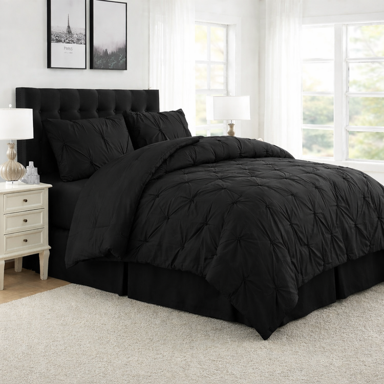 Black bedding set on a bed in a well-lit bedroom