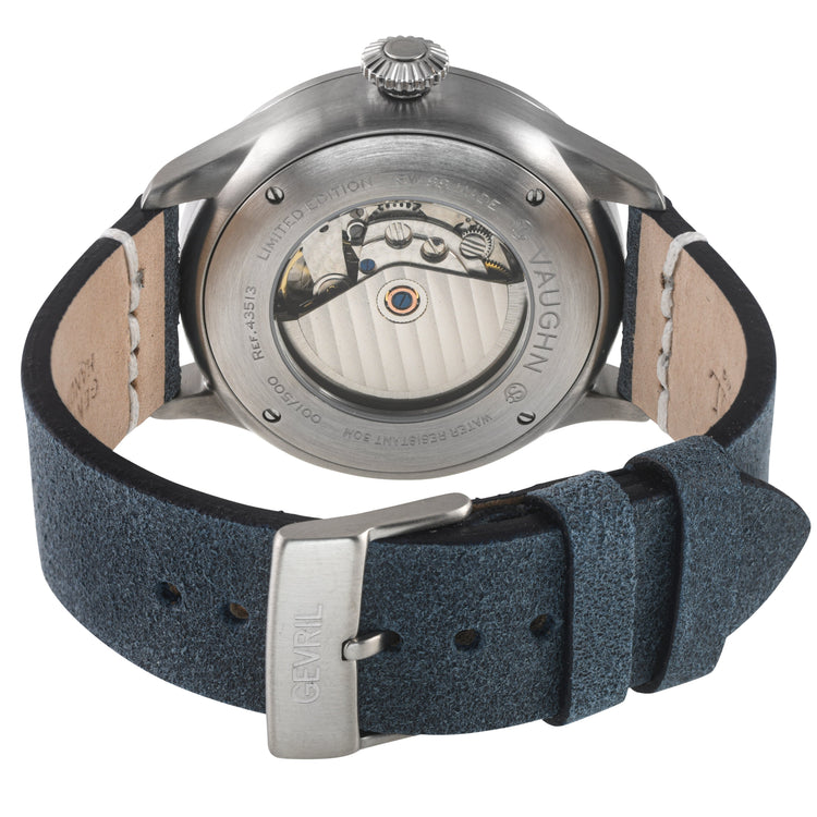 Watch with black leather strap and visible mechanism on a white background