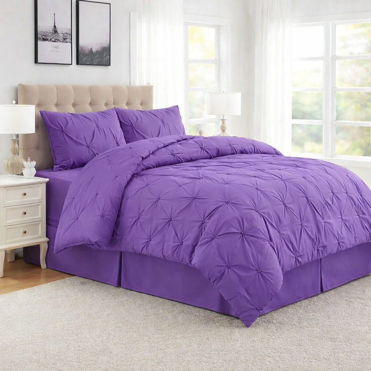 Purple bedding set on a bed in a well-lit bedroom
