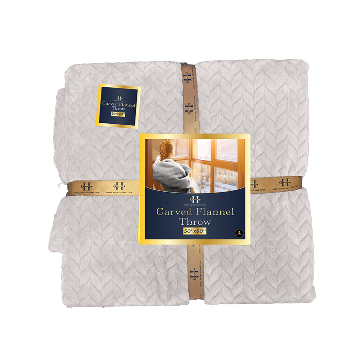 Folded flannel throw blanket with brand label on a white background