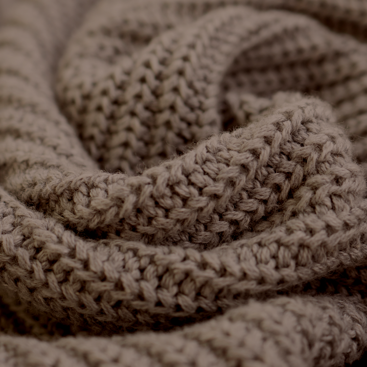Close-up of a knitted beige fabric