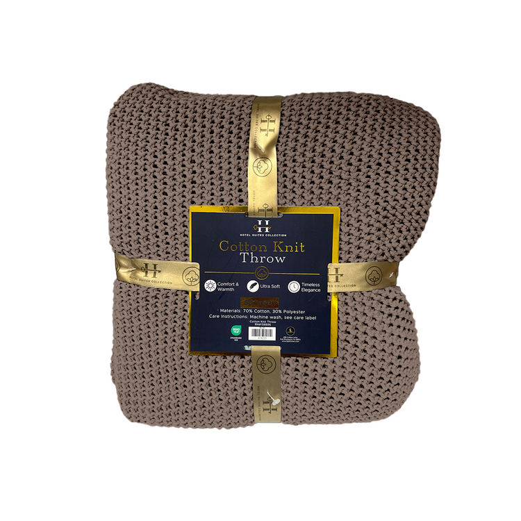 Brown knit throw blanket with a gold label on a white background