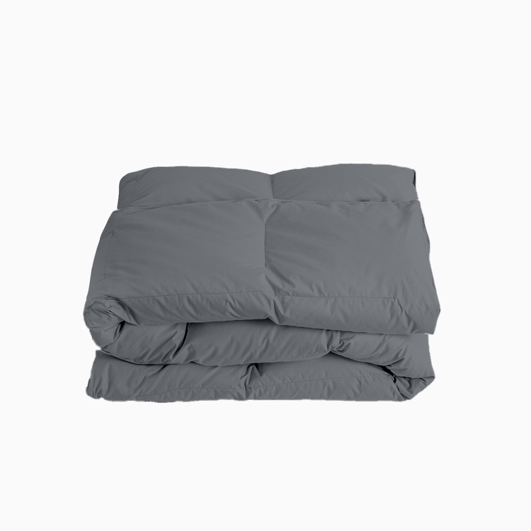 Folded gray comforter on a white background